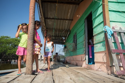 Young girls played on their porch while a family member mended a shrimp net in Buenavista.